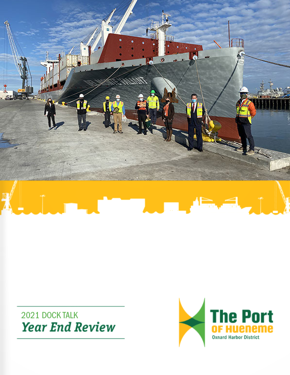 People wearing safety gear are standing on a dock near a large cargo ship. The image is featured in the "2021 Dock Talk Year End Review" newsletter for The Port of Hueneme.