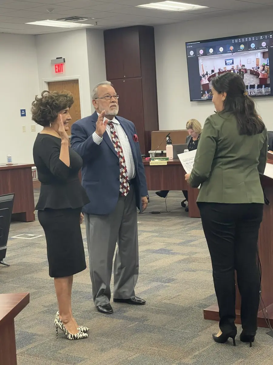 A man in a suit is sworn in by a woman in a green blazer, while another woman raises her hand, marking the announcement of a $3.935 million state grant for Port of Hueneme. A virtual meeting is visible on the screen as Californias port data partnership program gains momentum under the governors initiative.